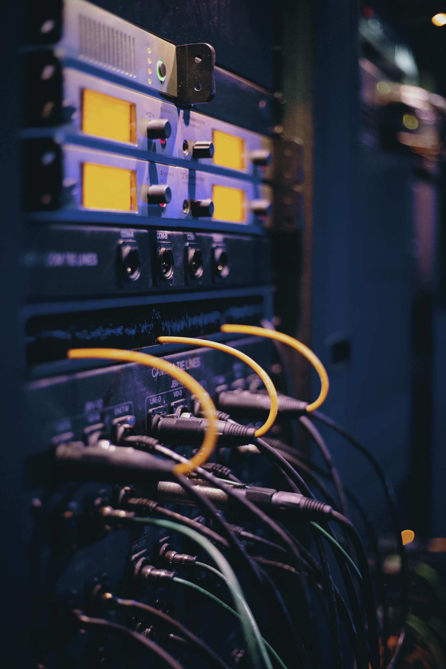 Close-up of network cables and ports in a server rack, showcasing connectivity.